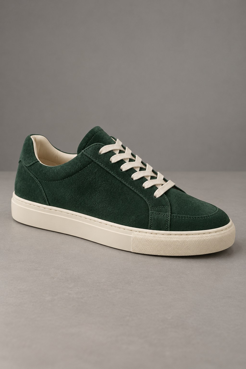 Green suede sneaker on grey before background removal — AI-generated demonstration